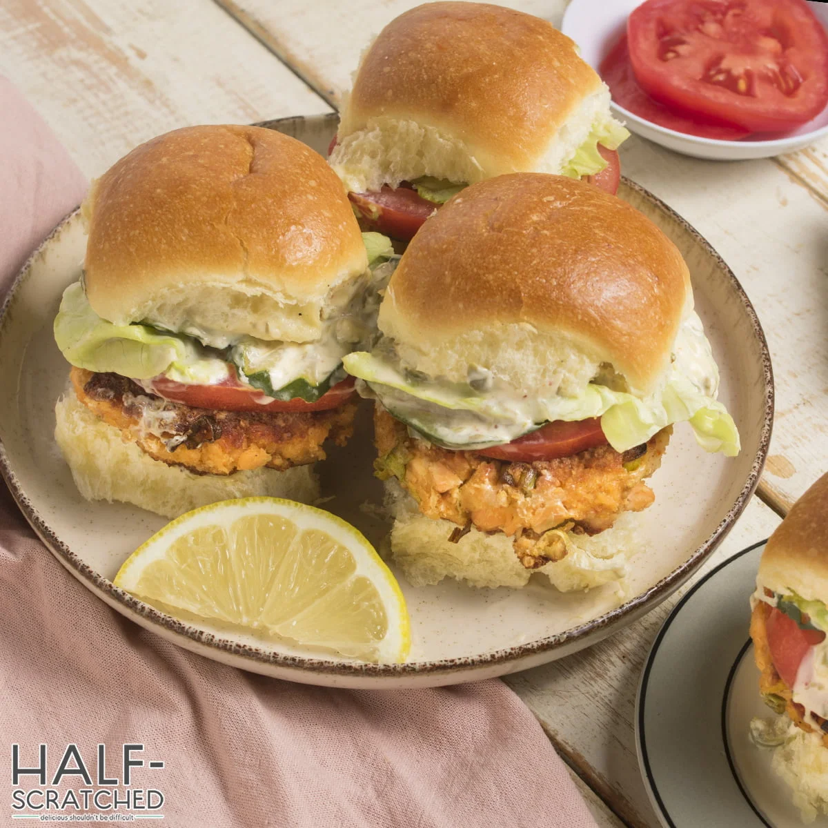 Three salmon patties sandwiches