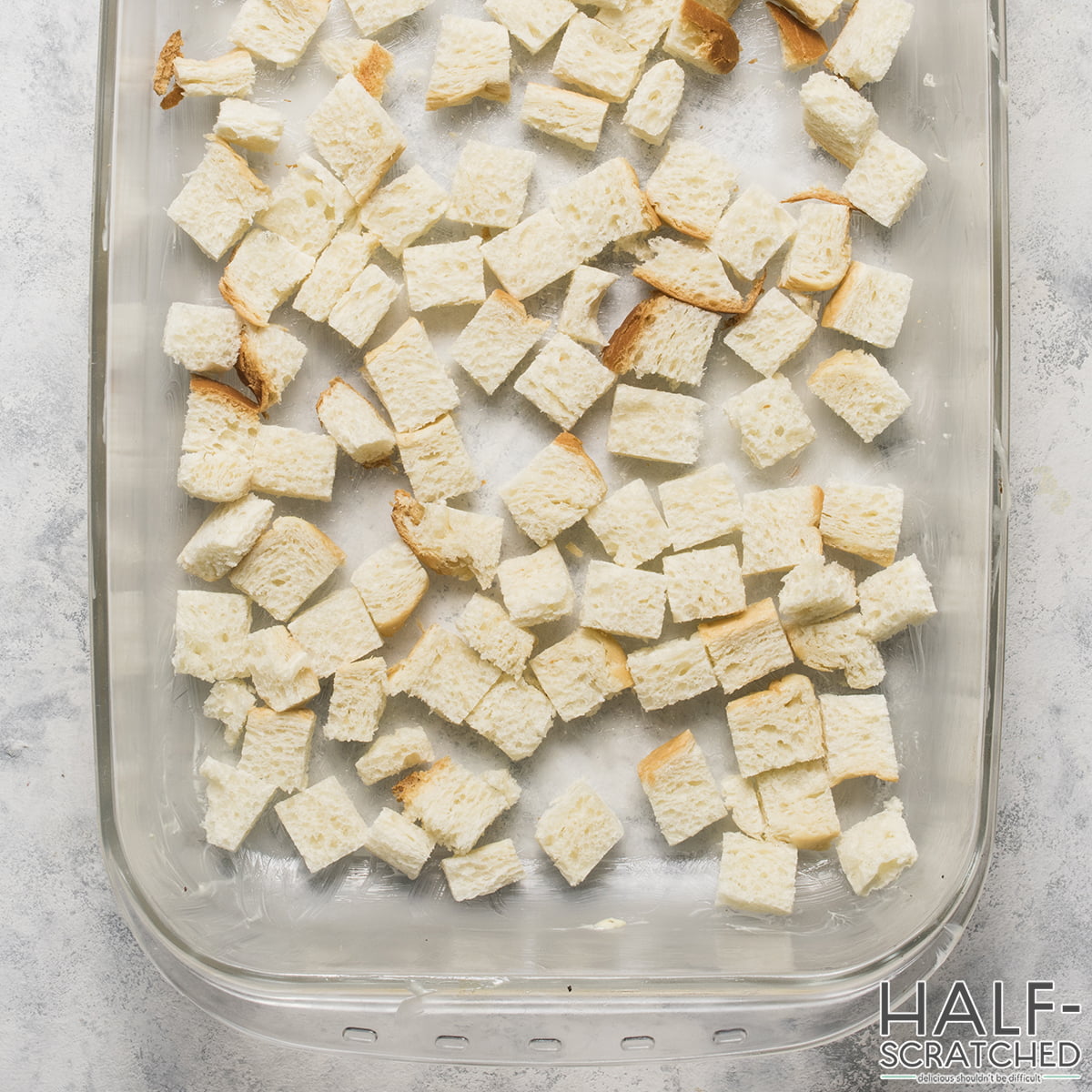 Pieces of bread cut into cubes in a baking dish