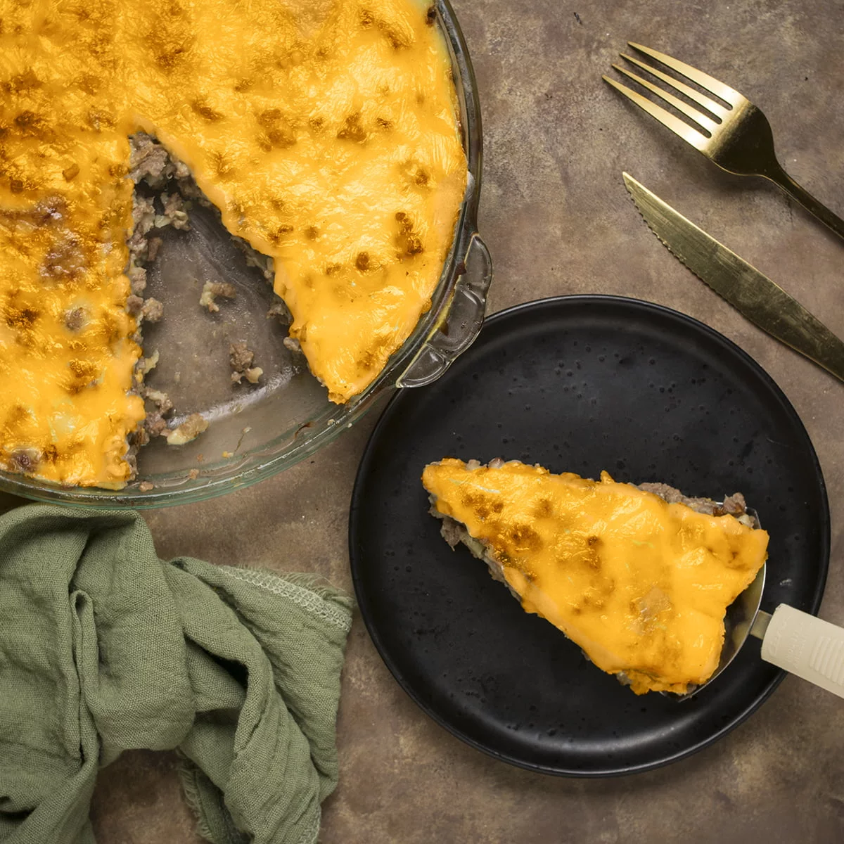 A plate with a slice of pioneer woman cheeseburger pie