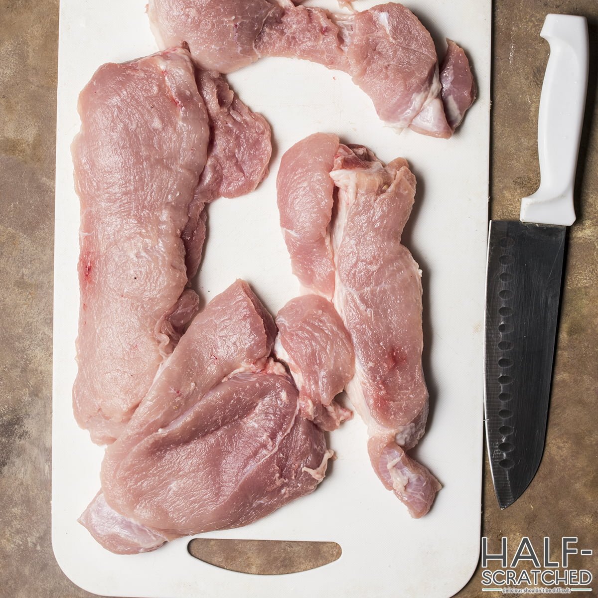 Four equal-sized chunks of pork butt