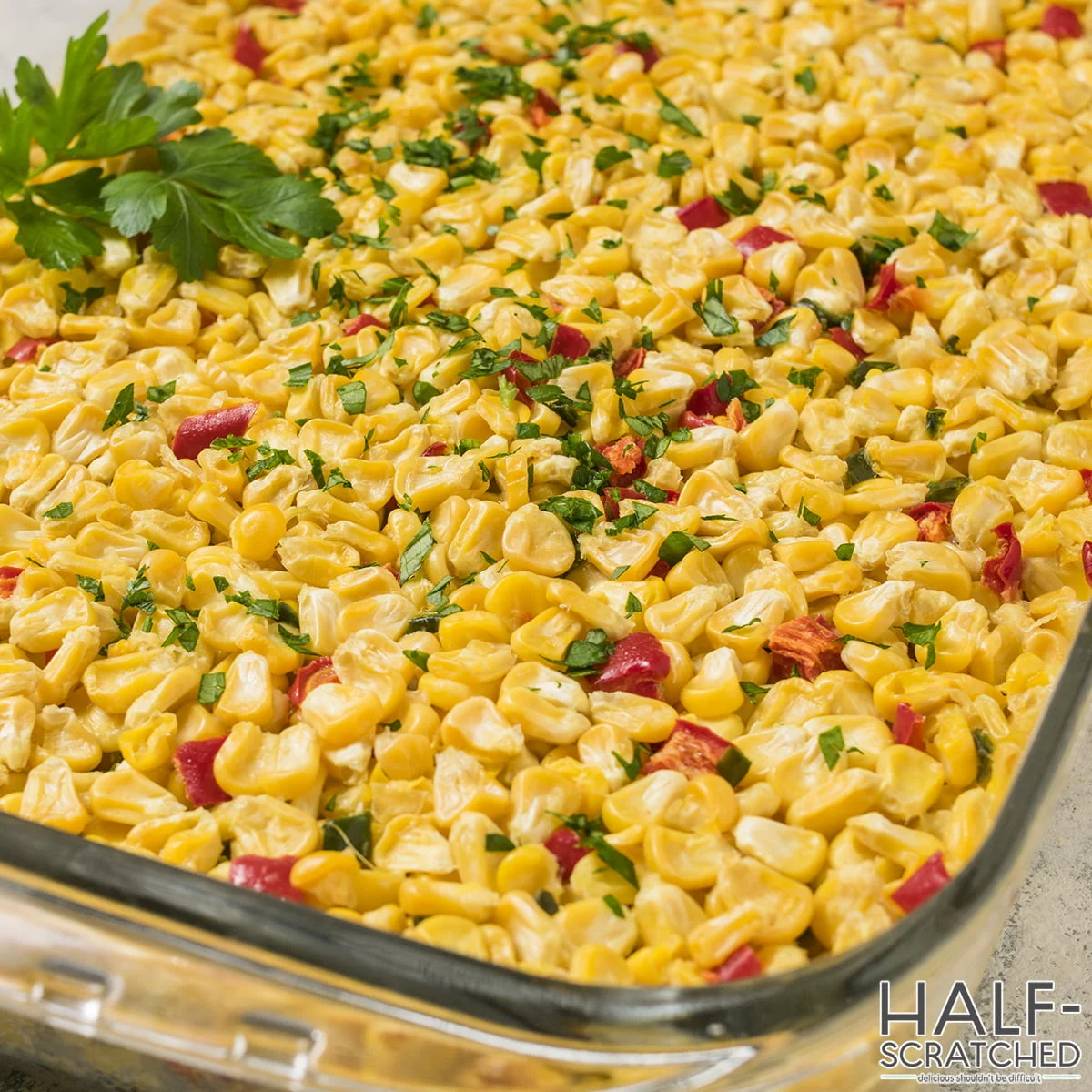 Close-up of corn kernels in the casserole with red bell peppers