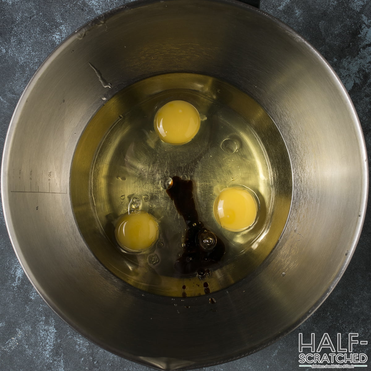 Eggs and vanilla extract in a mixing bowl