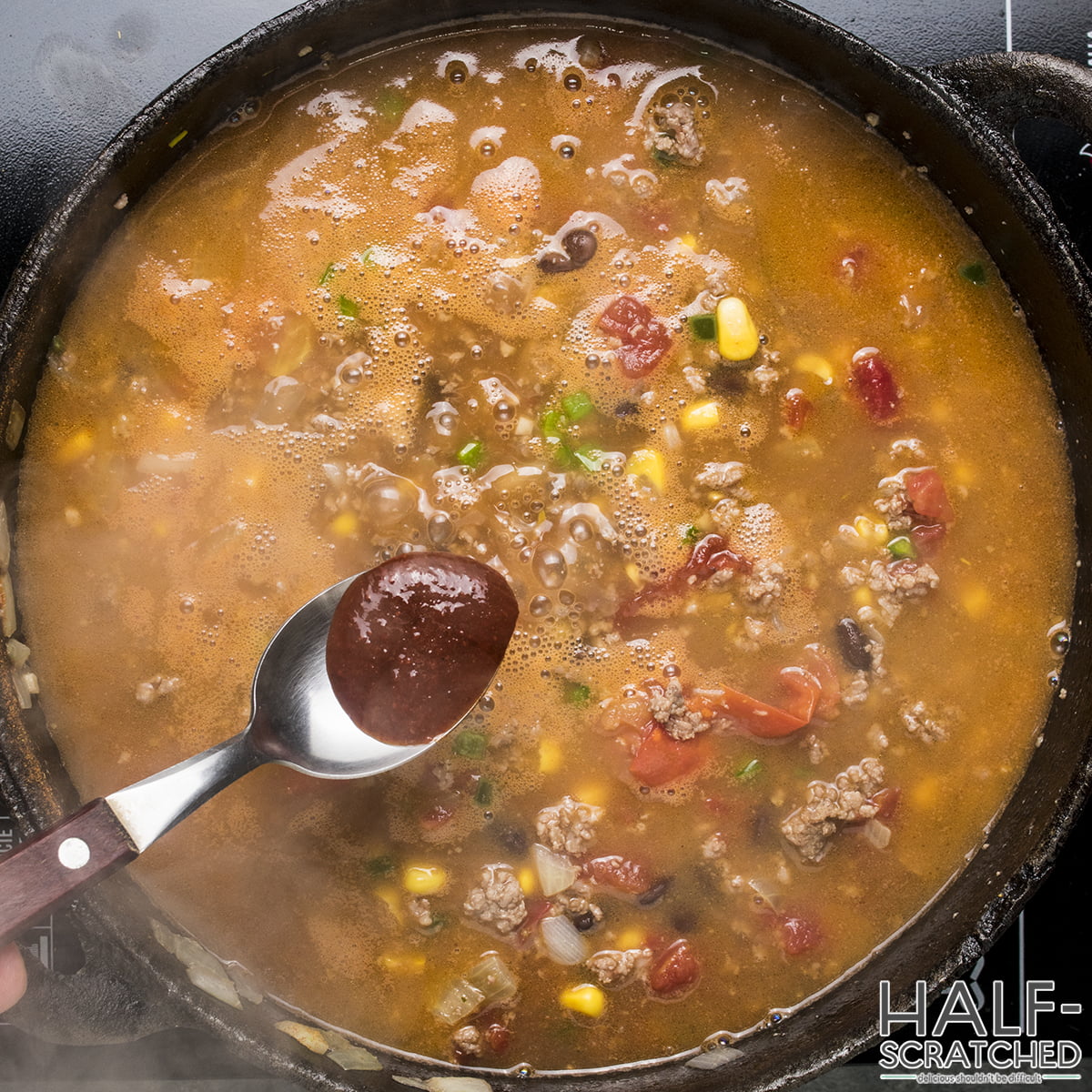 Adding hot sauce to the taco soup mixture