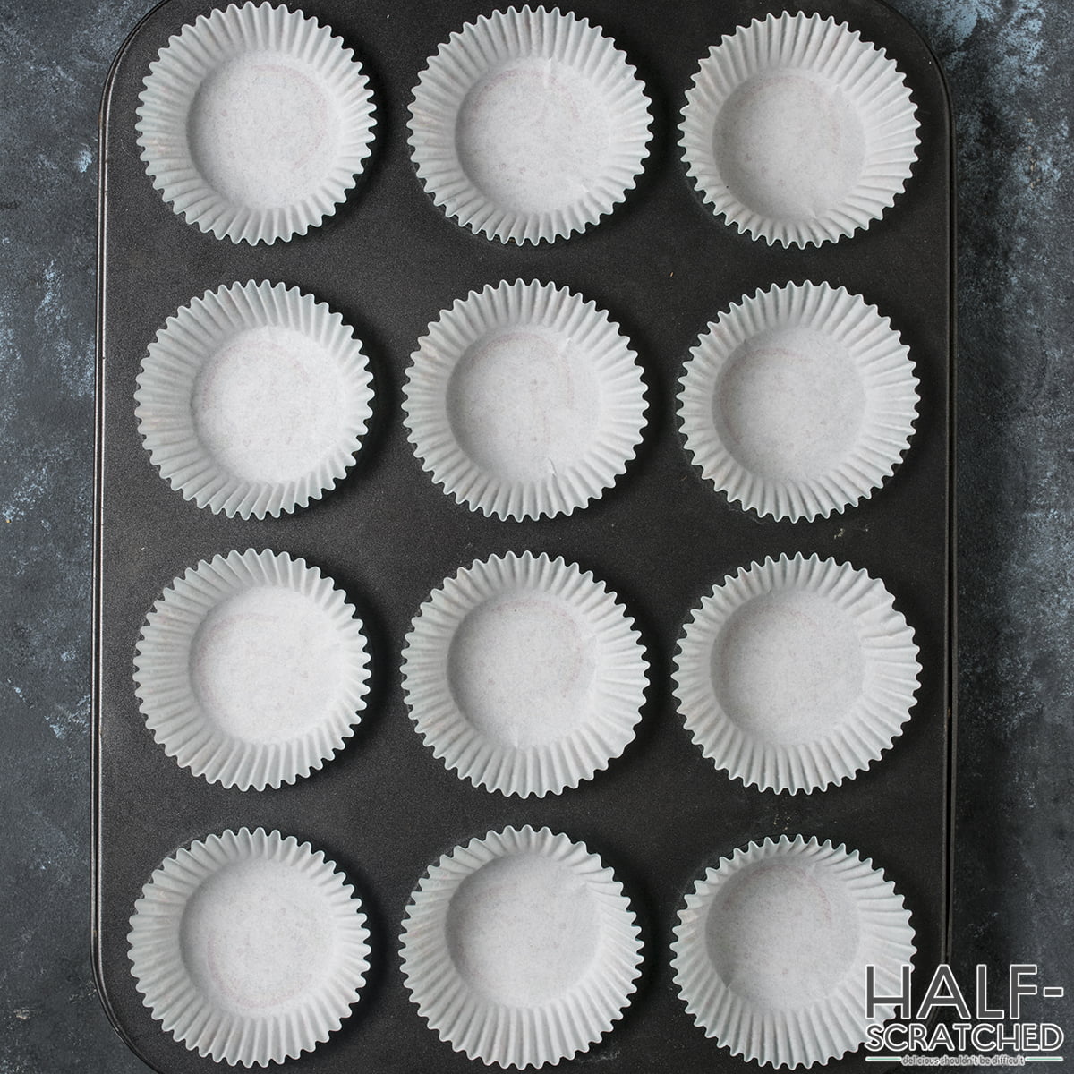 Empty lined muffin pans ready for batter