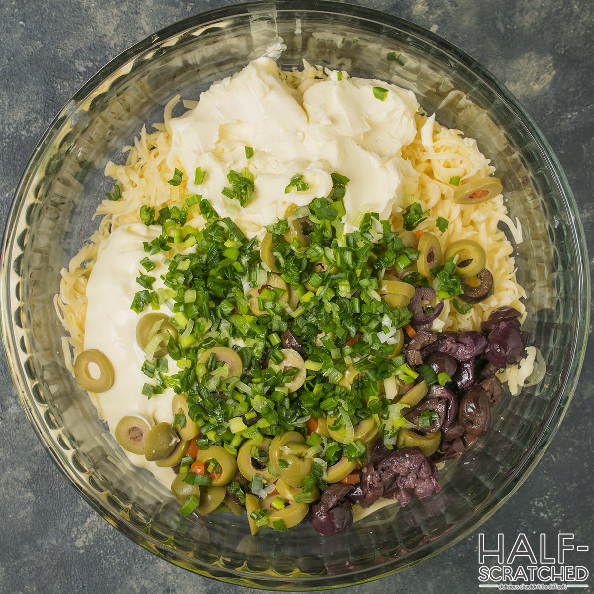 Bowl with cheese, olives, green onions, and other ingredients for olive bread