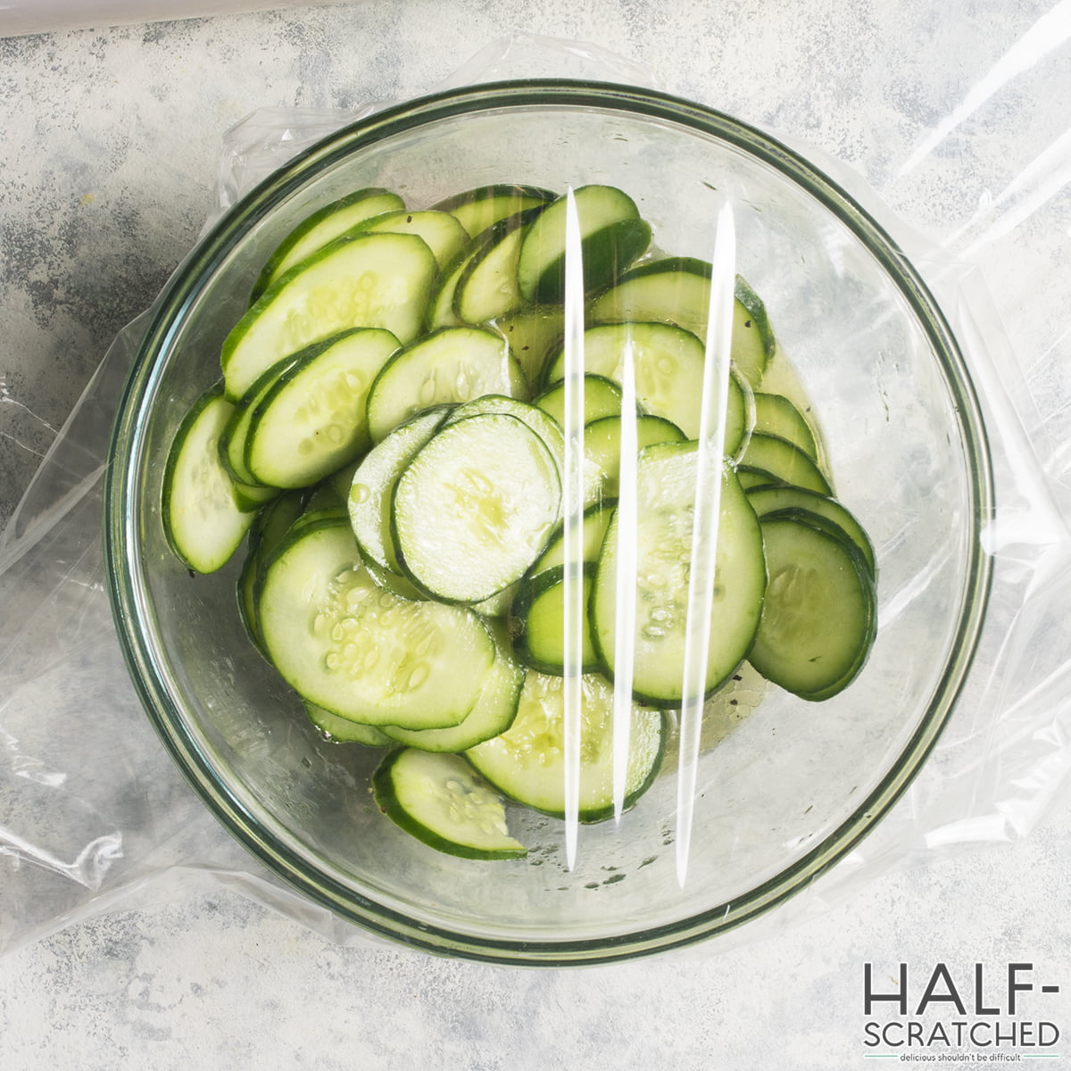 Covering cucumber slices with plastic wrap