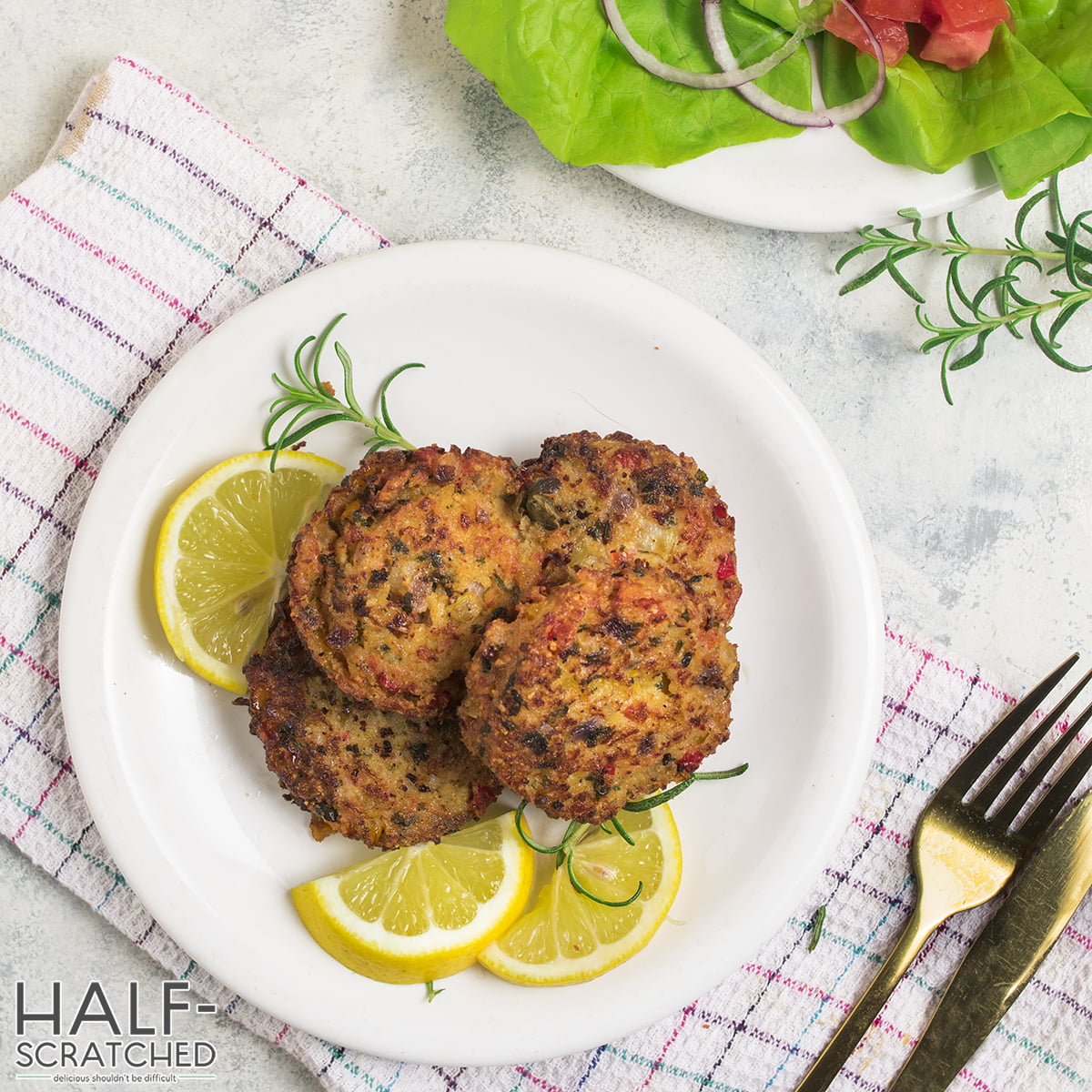 Top view of crab cakes with lemon slices