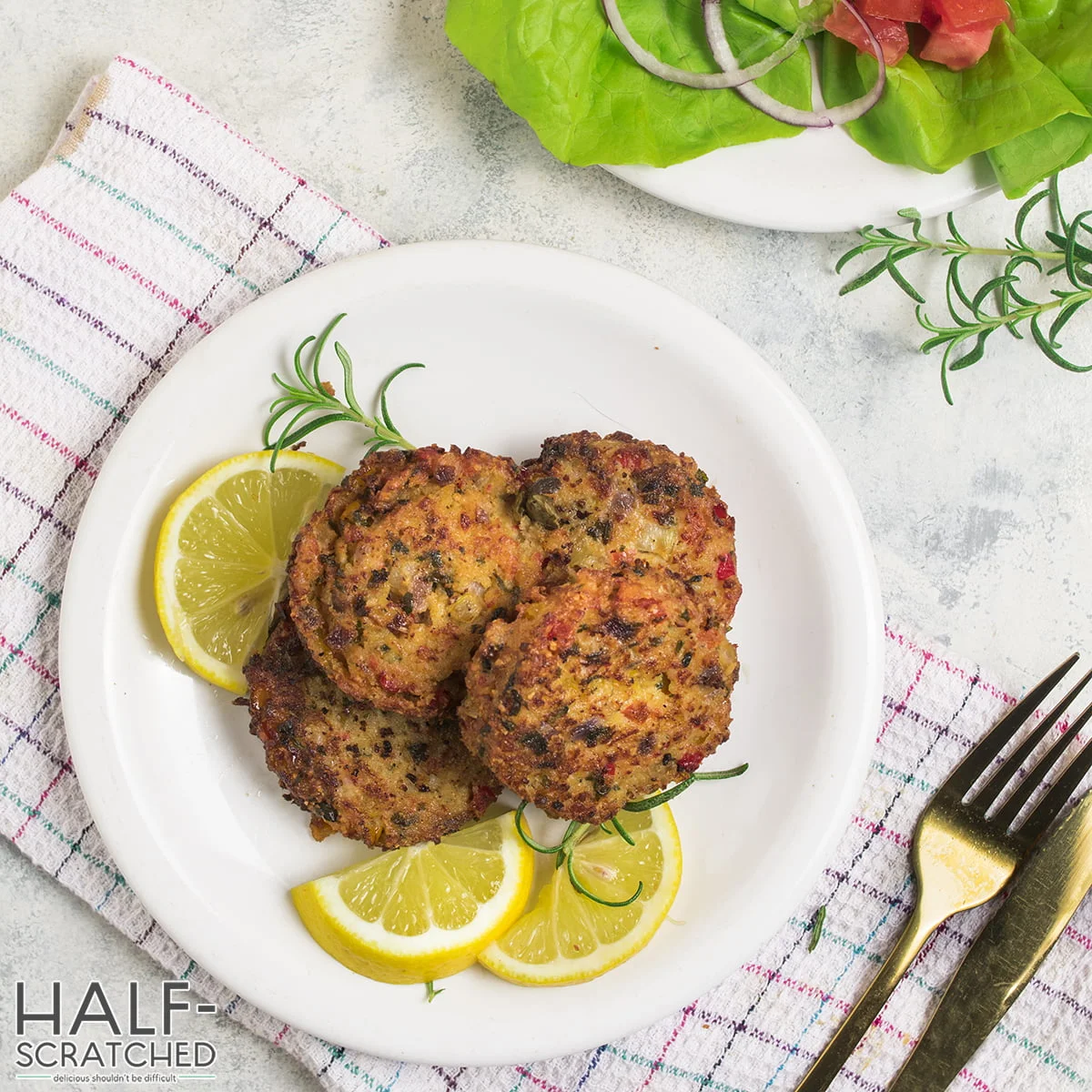 Top view of crab cakes with lemon slices