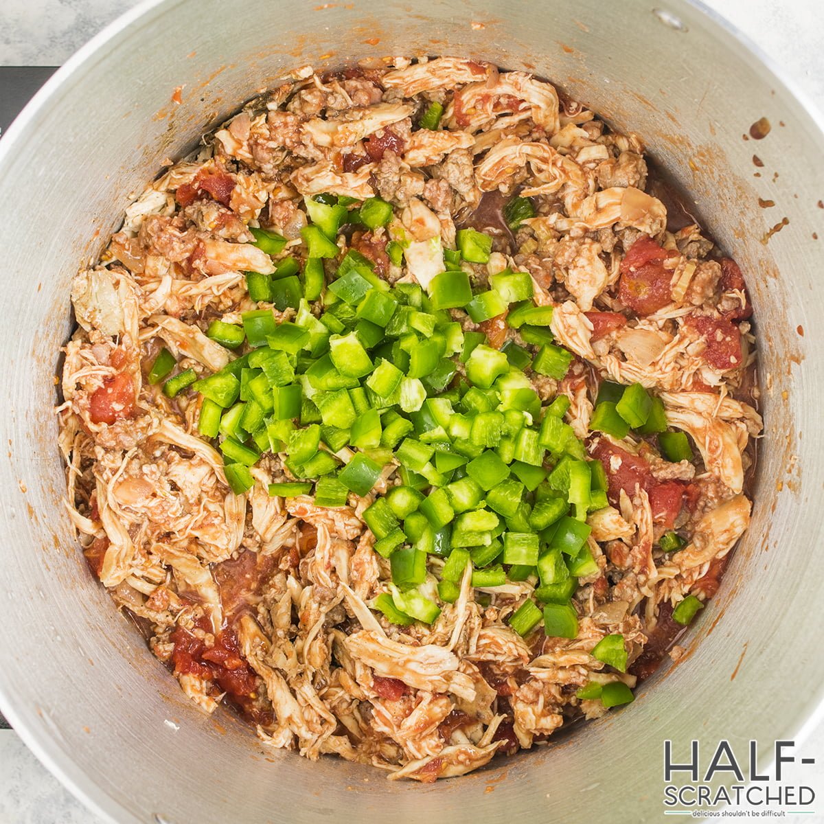 Brunswick Stew with diced green peppers in a pot