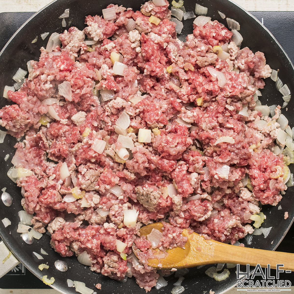 Ground beef and onions sautéing in a skillet