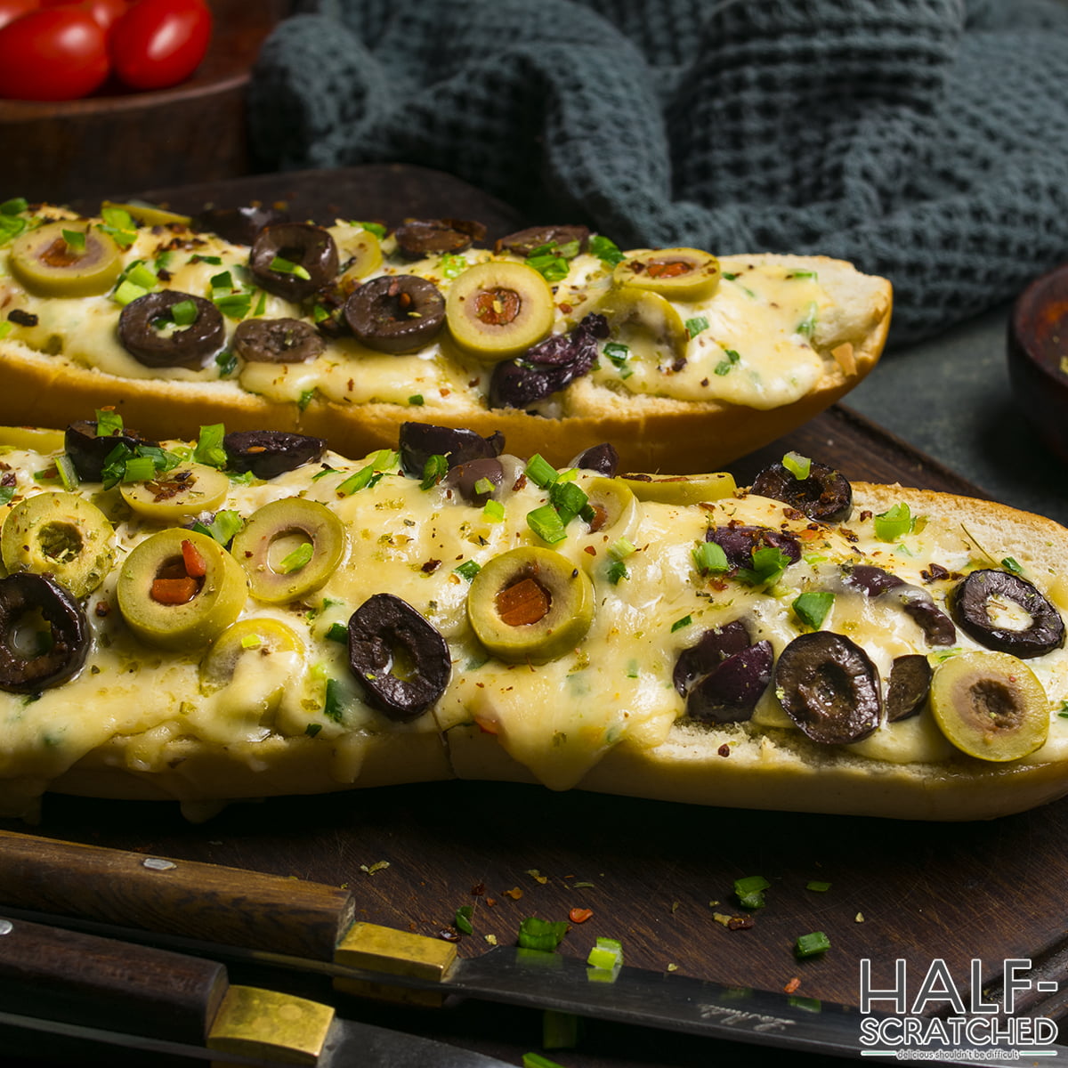 Baked olive bread with melted cheese and olives