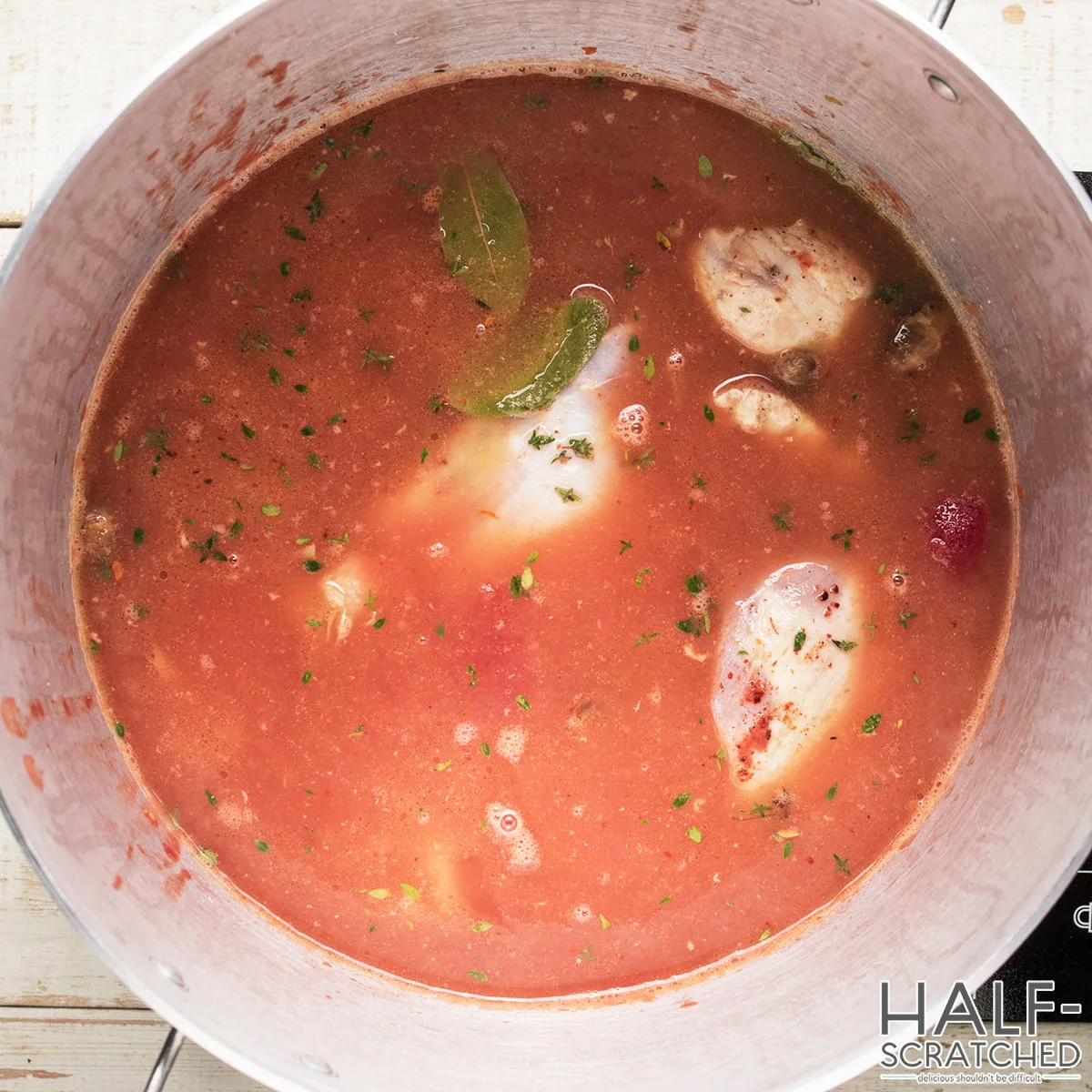 Chicken cacciatore cooking in tomato sauce