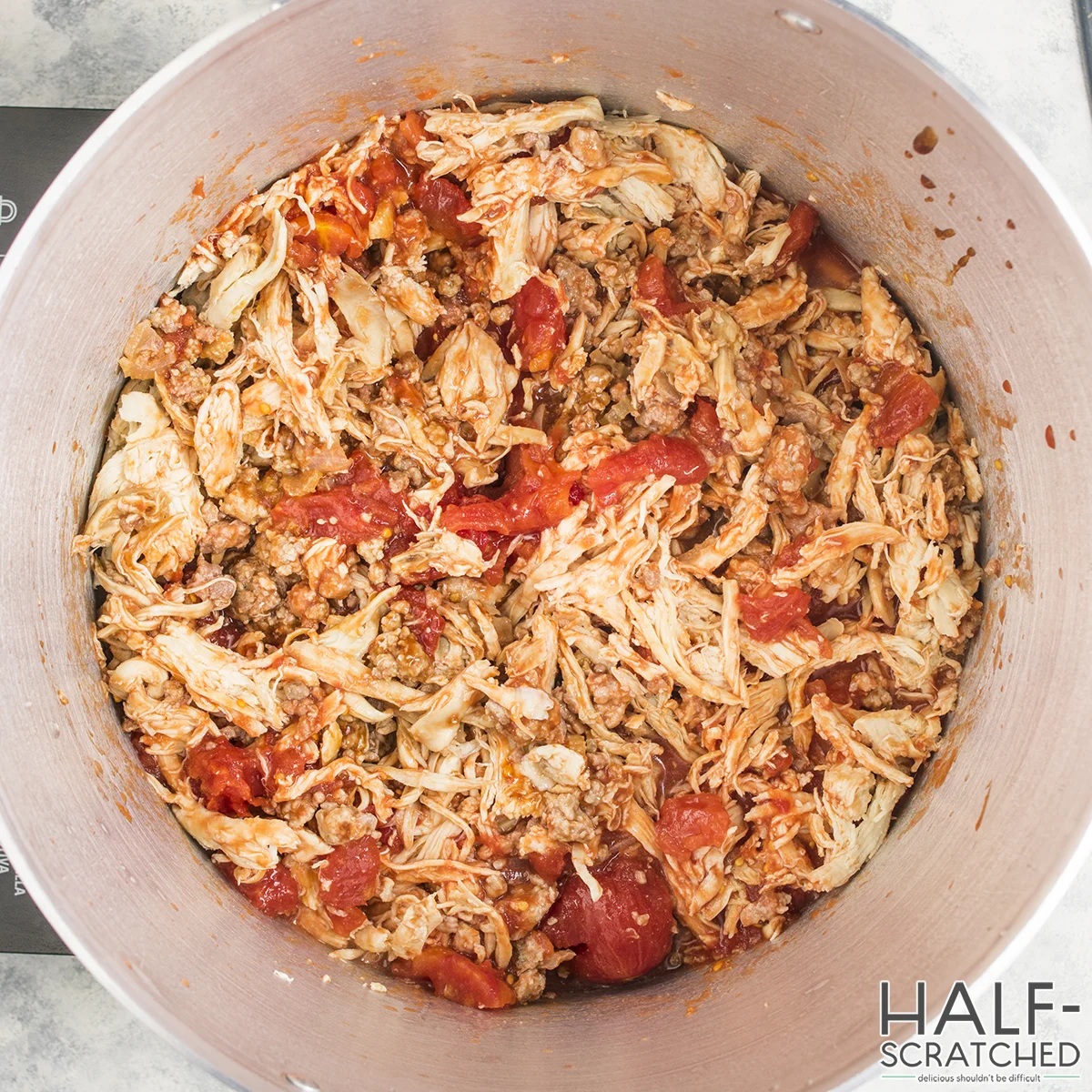 Brunswick Stew with shredded chicken and tomatoes in a pot