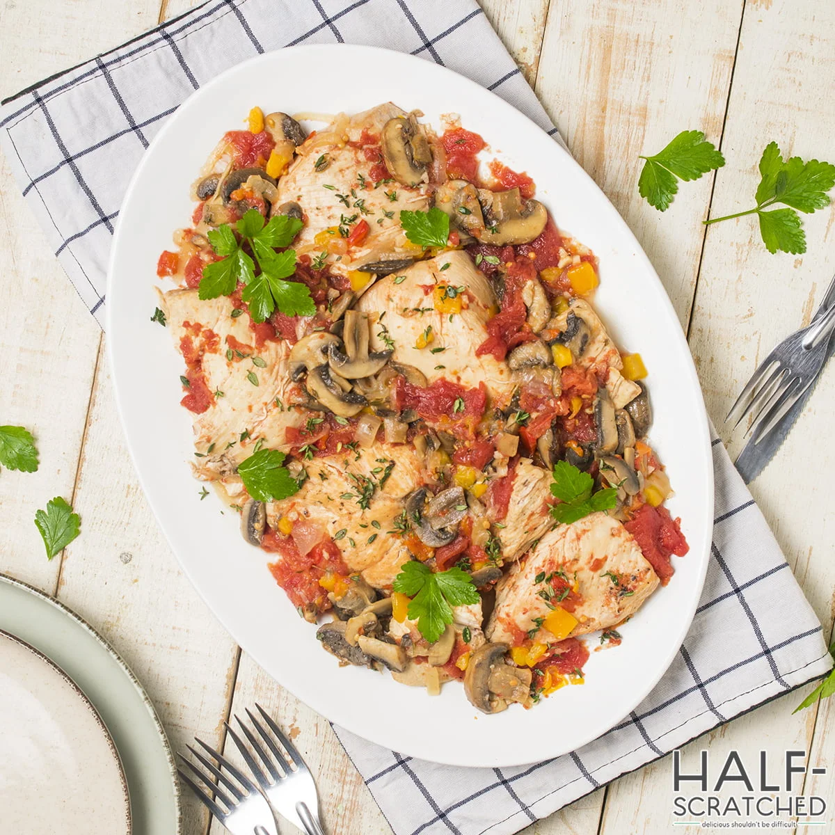 Large plate of chicken cacciatore with mushrooms and bell peppers