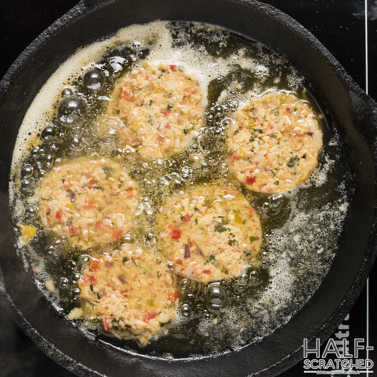 Crab cakes frying in a pan