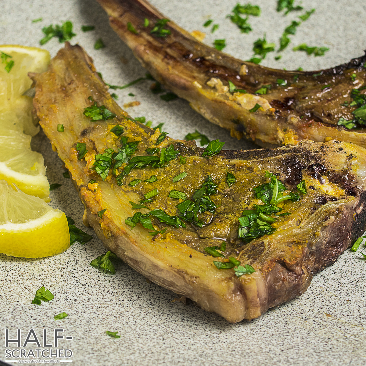 Cooked lamb chops garnished with parsley and lemon slices