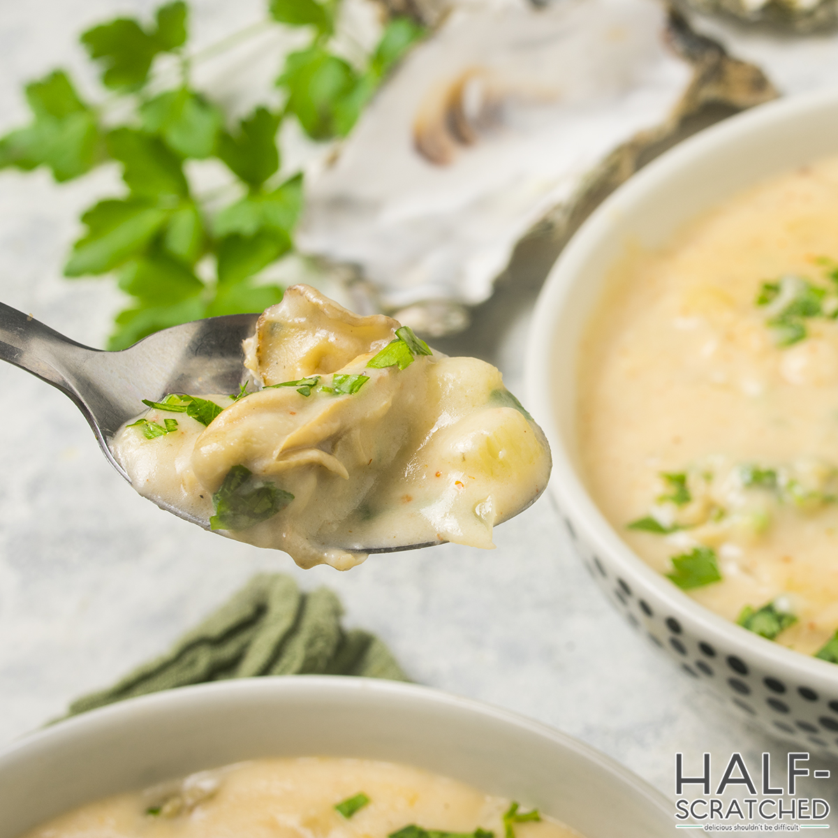 Spoonful of oyster stew with parsley